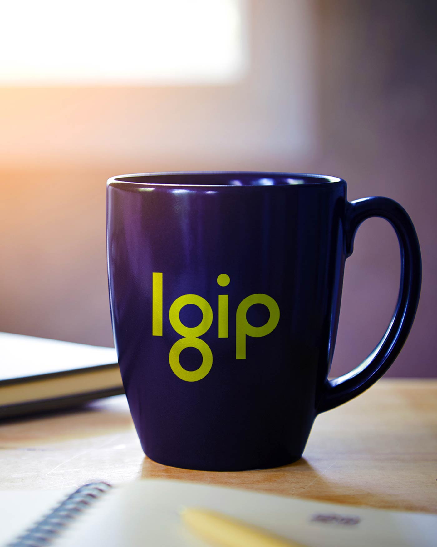 LGIP branded mug with modern lowercase logo in green.